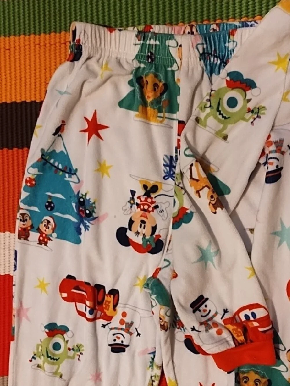 Disney Kids Holiday Pajama Set - White with Red Accents and Multicolor Prints.